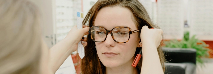 A person getting their glasses fitted.