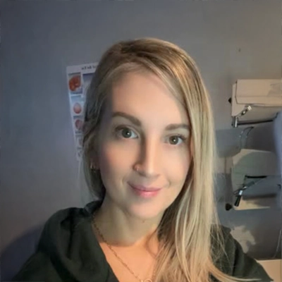 Michaela smiling, she has blonde hair.