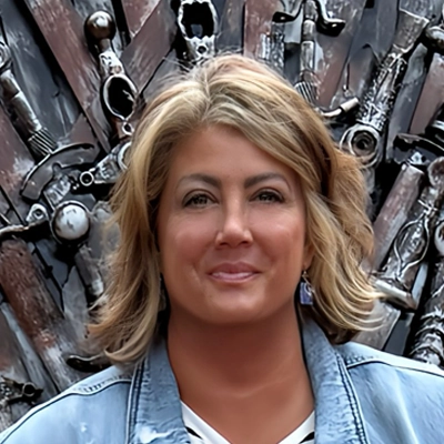 Nicole smiling in a jean jacket.
