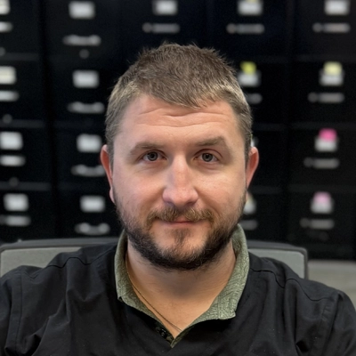 Peter Merchand smiling in a black shirt.