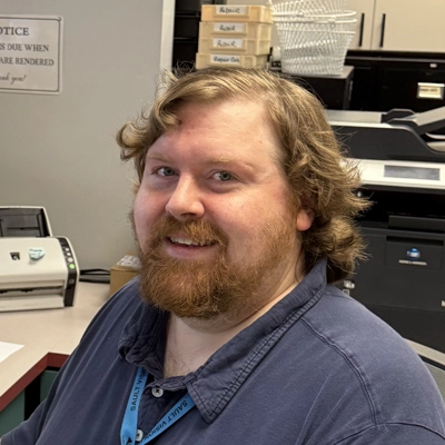 Sean smiling in a blue shirt.